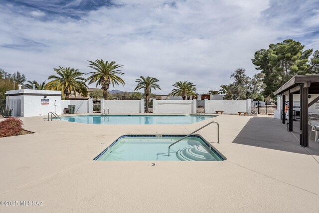 pool featuring a patio area and fence