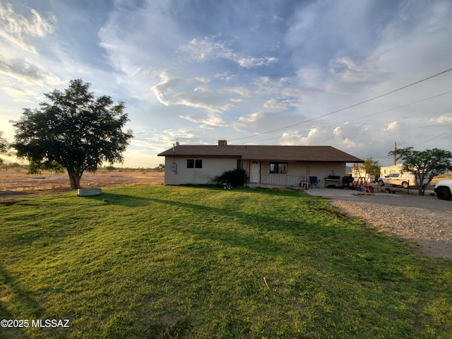 ranch-style home featuring a front yard