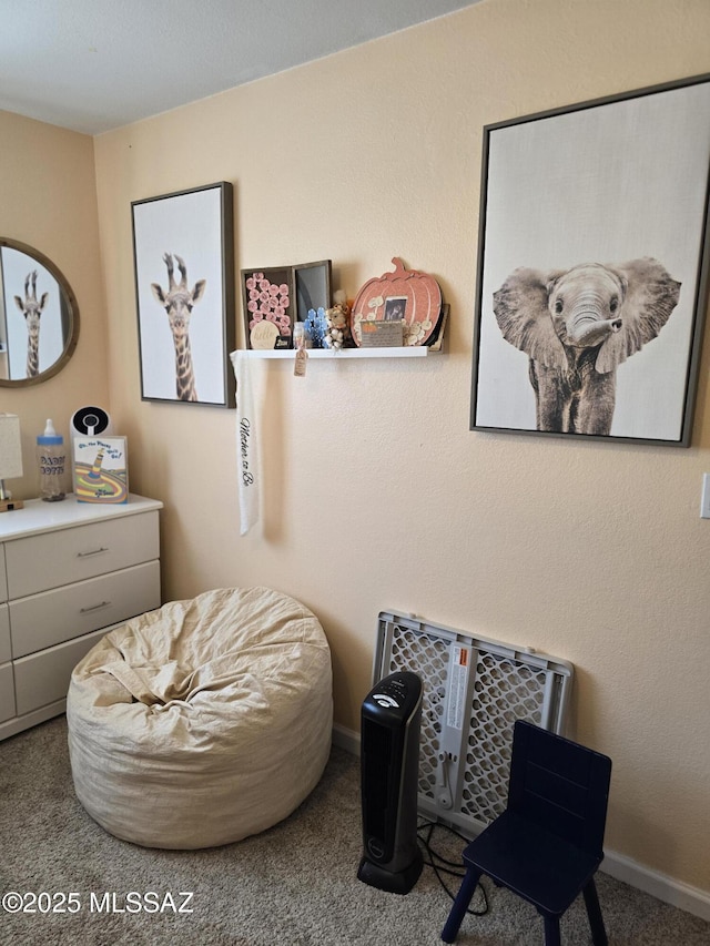 sitting room with baseboards and carpet floors