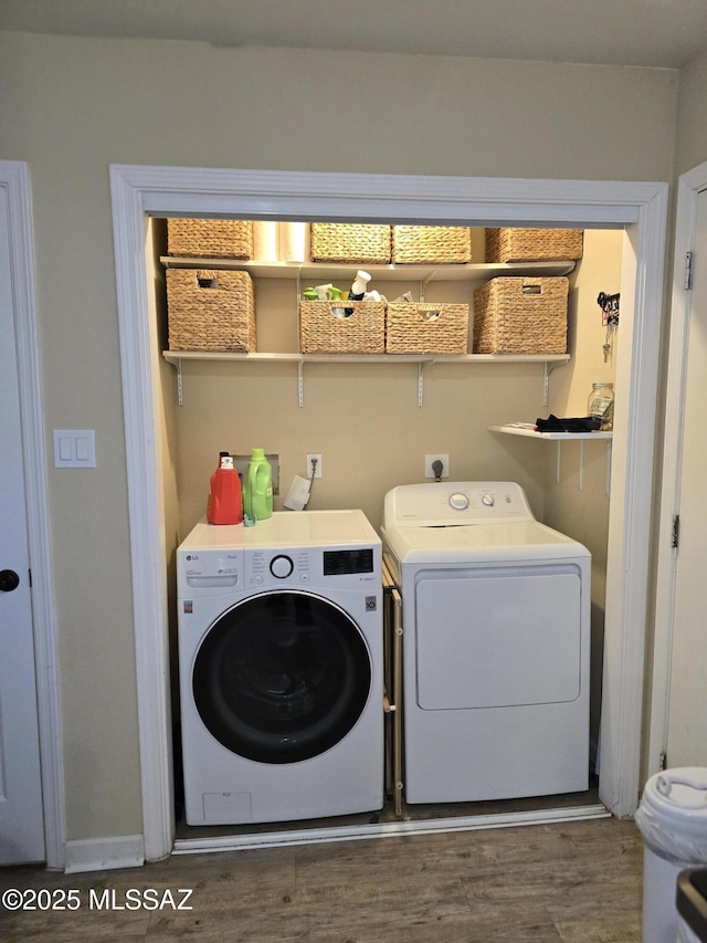 clothes washing area with laundry area, independent washer and dryer, and wood finished floors