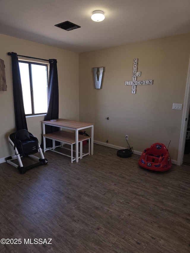 miscellaneous room featuring visible vents, baseboards, and wood finished floors