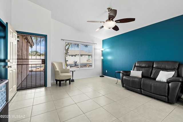 tiled living area with baseboards, lofted ceiling, and ceiling fan