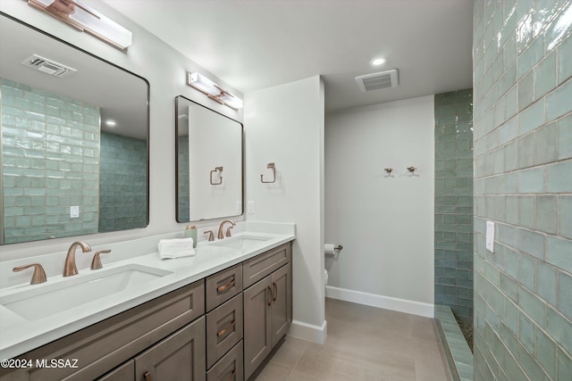 bathroom with visible vents, a stall shower, and a sink