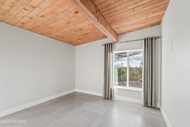 empty room featuring baseboards, wooden ceiling, and visible vents