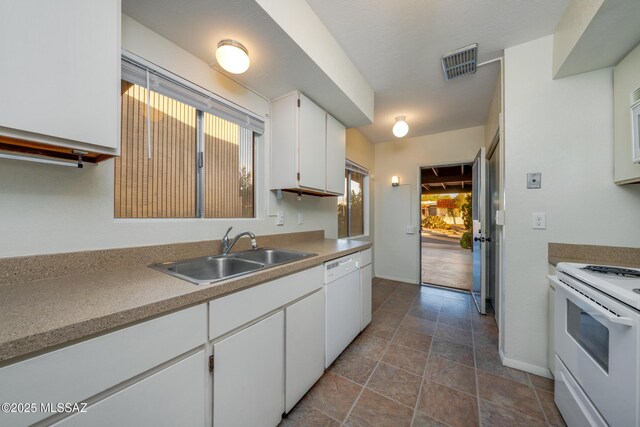 418 N Calle De Las Profetas, Green Valley, AZ 85614 - kitchen with white appliances, a sink, white cabinets, and plenty of natural light