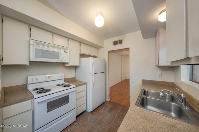 418 N Calle De Las Profetas, Green Valley, AZ 85614 - kitchen with white appliances, a sink, light countertops, and dark stone finish floors
