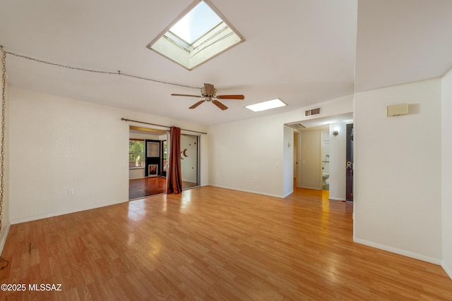 418 N Calle De Las Profetas, Green Valley, AZ 85614 - spare room featuring a skylight, light wood finished floors, a ceiling fan, and baseboards