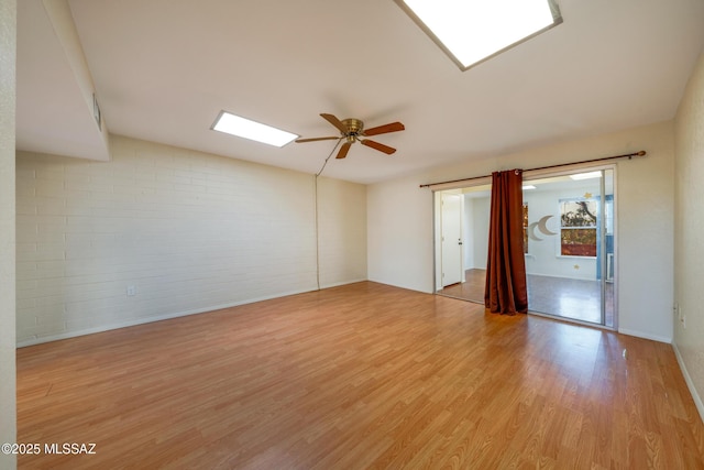 418 N Calle De Las Profetas, Green Valley, AZ 85614 - empty room with brick wall, ceiling fan, and light wood-style floors