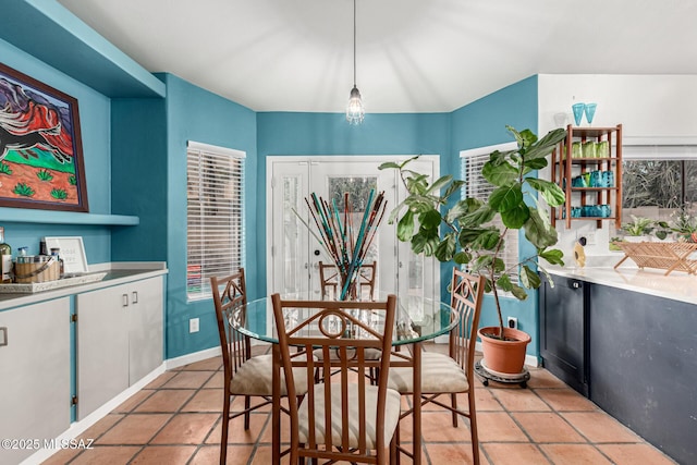 dining room with light tile patterned floors and baseboards