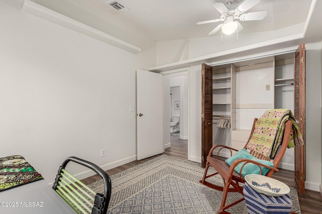 living area with baseboards, visible vents, lofted ceiling, ceiling fan, and wood finished floors