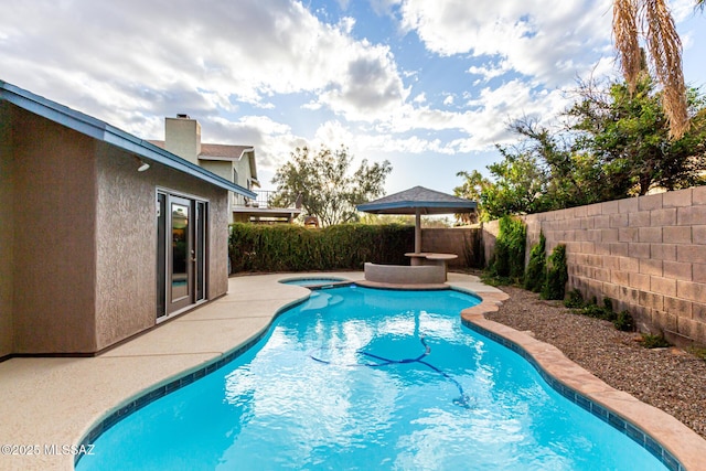 view of pool featuring a patio, a fenced backyard, and a fenced in pool