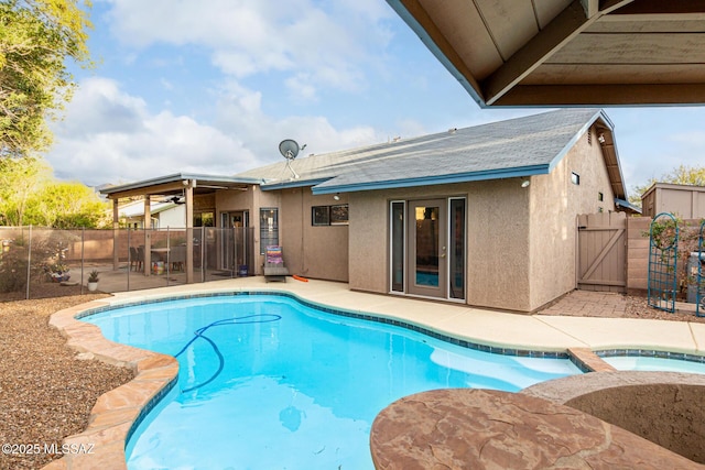 view of pool featuring a fenced in pool, an in ground hot tub, a gate, fence, and a patio area