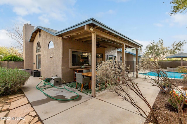 view of patio / terrace featuring ceiling fan, fence, outdoor dining area, and a fenced in pool