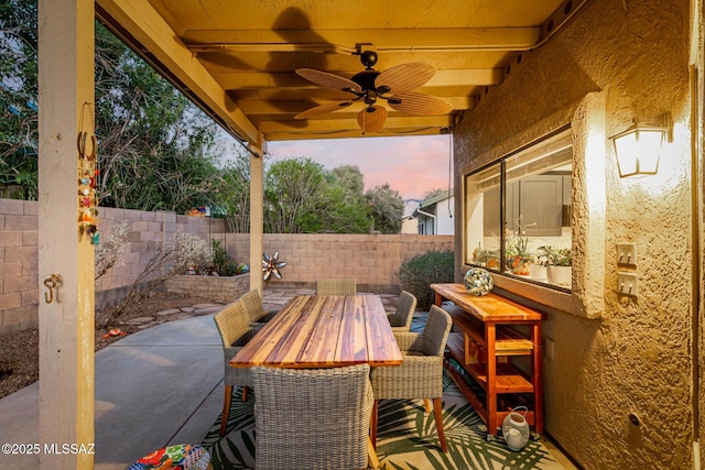 view of patio with outdoor dining space, a fenced backyard, and ceiling fan