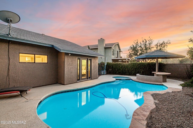 view of swimming pool with a patio area, fence, and a fenced in pool