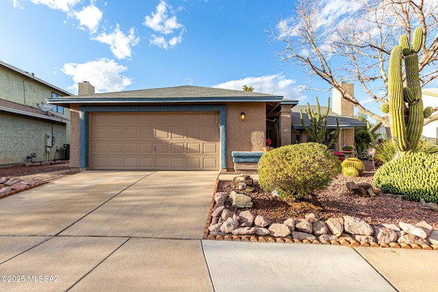 ranch-style house featuring an attached garage, concrete driveway, and stucco siding