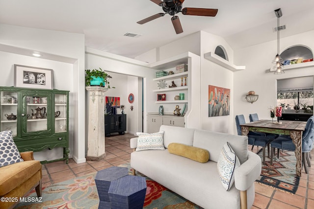 living area featuring light tile patterned flooring, visible vents, and a ceiling fan