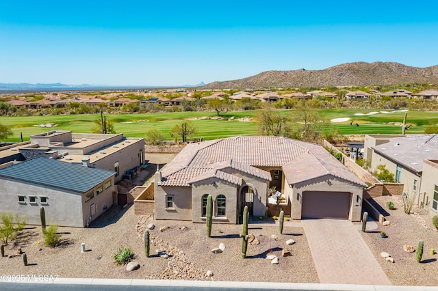 drone / aerial view with a mountain view and view of golf course