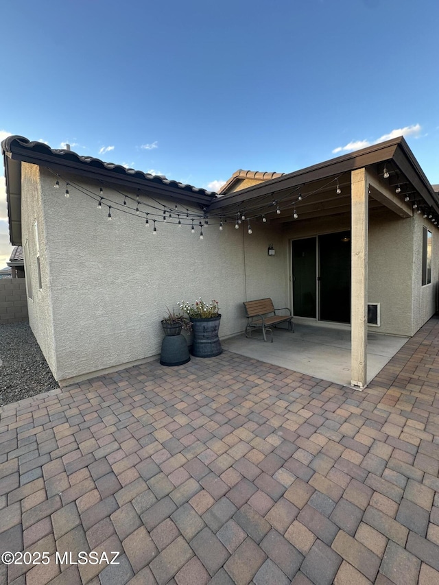 back of house with a patio, stucco siding, and fence