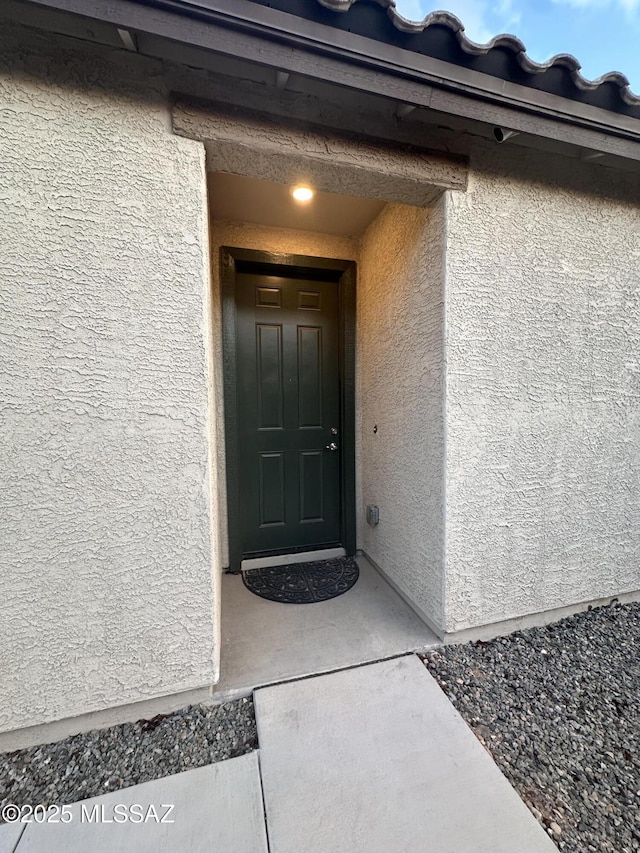 doorway to property with stucco siding