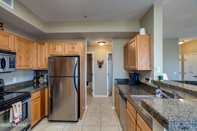 kitchen with light tile patterned floors, visible vents, baseboards, appliances with stainless steel finishes, and tile counters