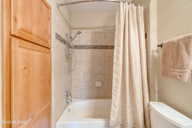 full bathroom featuring shower / bath combination with curtain, a textured wall, and toilet