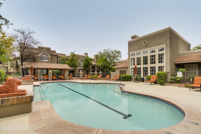 pool featuring a patio and fence