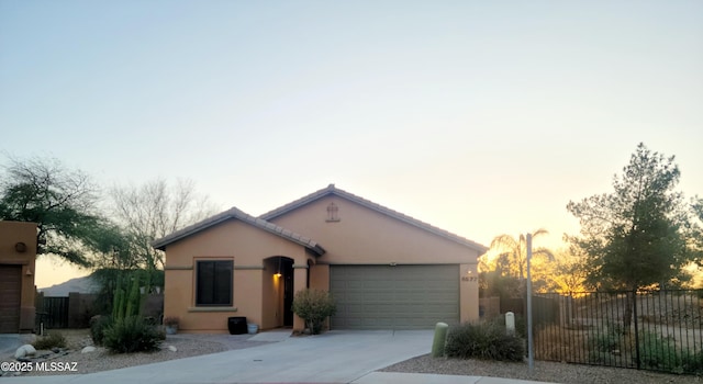 6577 W Sugar Pine Trl, Tucson, AZ 85743 - view of front facade with an attached garage, concrete driveway, and stucco siding