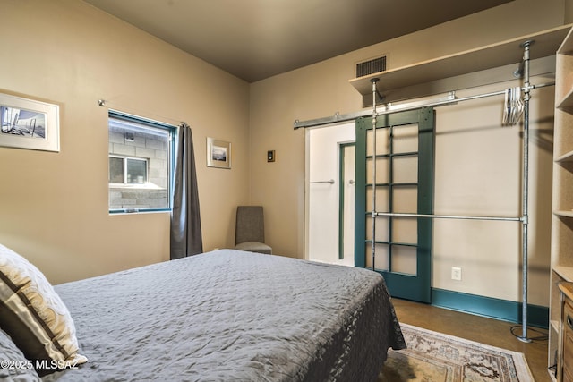 bedroom featuring concrete floors, visible vents, and baseboards