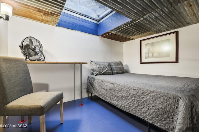 bedroom featuring finished concrete floors and a skylight