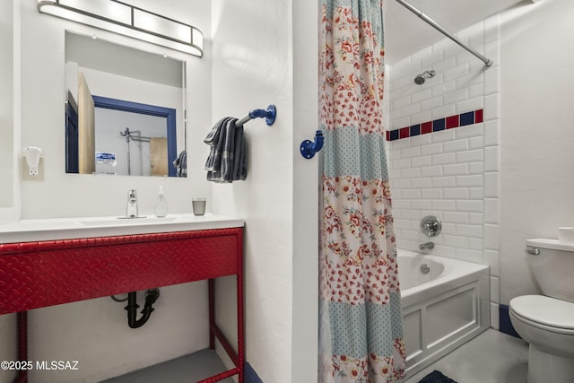 bathroom with shower / bath combination with curtain, a sink, and toilet