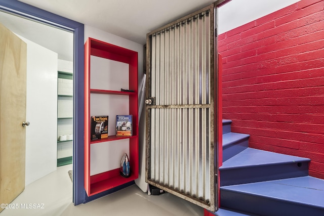 stairs featuring concrete floors