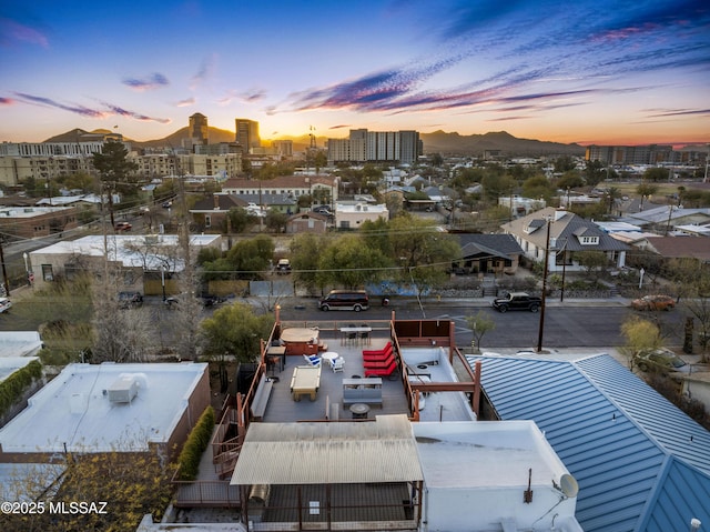 aerial view at dusk featuring a view of city