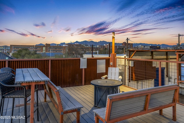 wooden deck featuring outdoor dining area and a mountain view