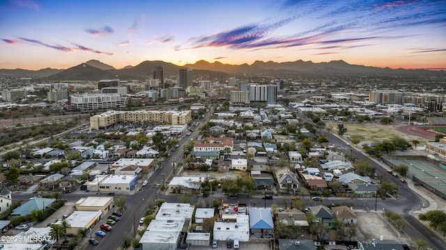 birds eye view of property with a view of city and a mountain view