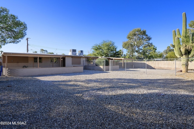 exterior space with central air condition unit and fence