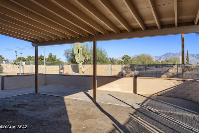 view of patio featuring a fenced backyard and a mountain view