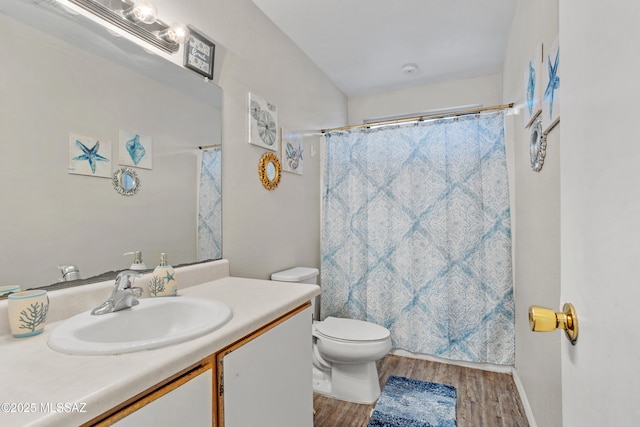 bathroom featuring vanity, curtained shower, wood finished floors, and toilet