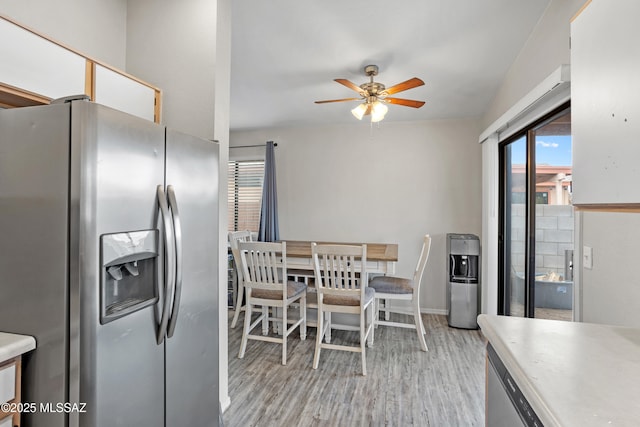 kitchen featuring a healthy amount of sunlight, ceiling fan, light wood finished floors, and stainless steel fridge with ice dispenser