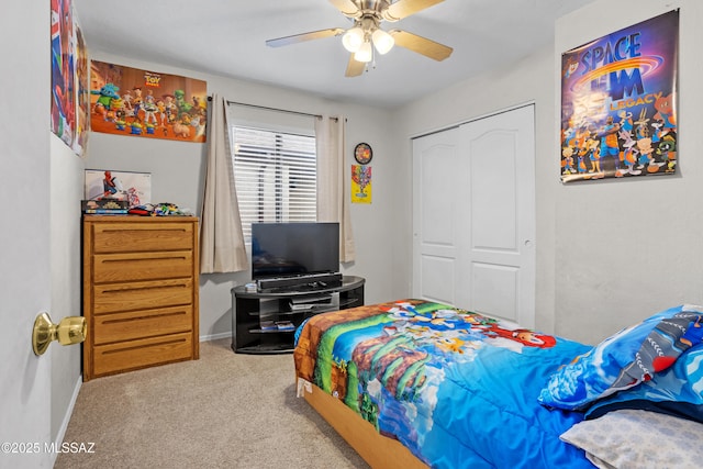 bedroom with a ceiling fan, carpet, baseboards, and a closet