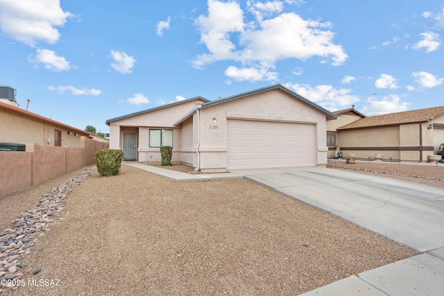 ranch-style house with a garage, concrete driveway, fence, and stucco siding