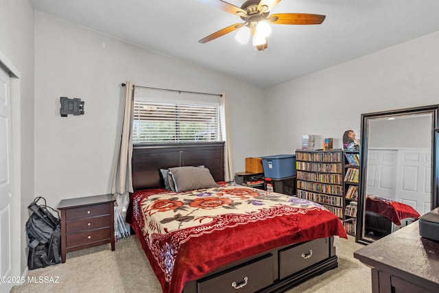 bedroom featuring light carpet, a closet, vaulted ceiling, and a ceiling fan