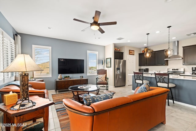 living area with recessed lighting, a ceiling fan, visible vents, and light tile patterned floors