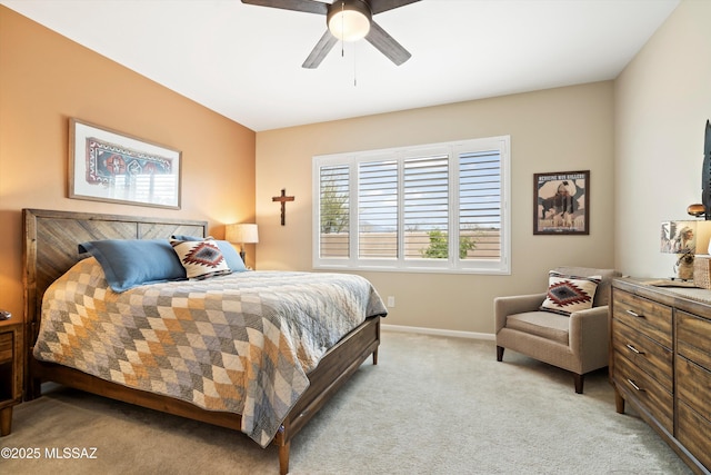 bedroom with light carpet, ceiling fan, and baseboards