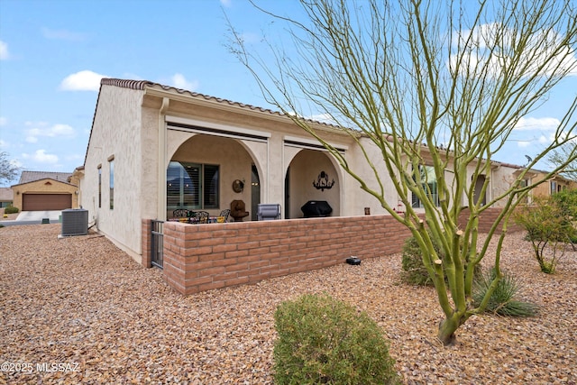 exterior space featuring central AC and stucco siding