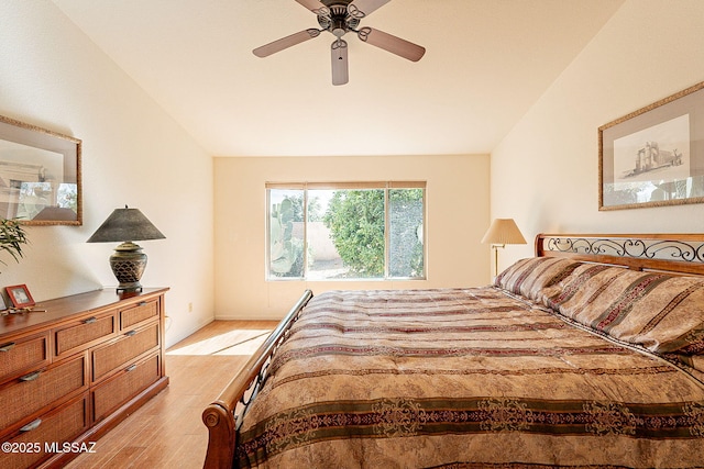 bedroom with vaulted ceiling, ceiling fan, and light wood-type flooring