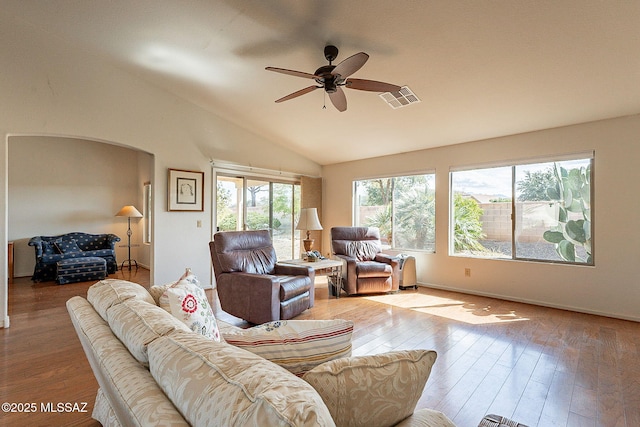 living room with lofted ceiling, visible vents, ceiling fan, and wood finished floors