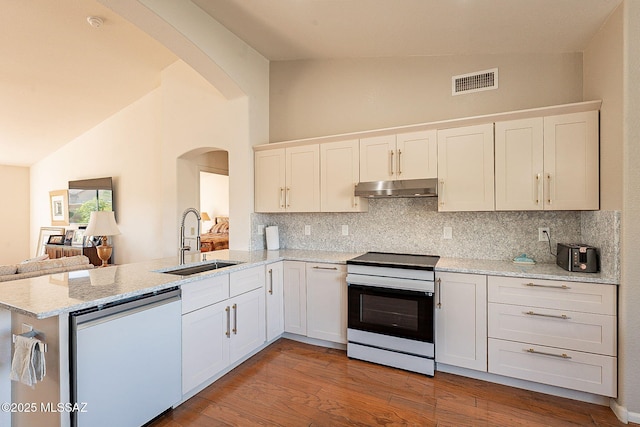 kitchen with dishwashing machine, under cabinet range hood, range with electric stovetop, a sink, and visible vents