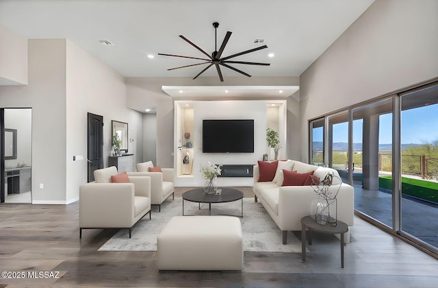 living area with plenty of natural light, wood finished floors, and visible vents