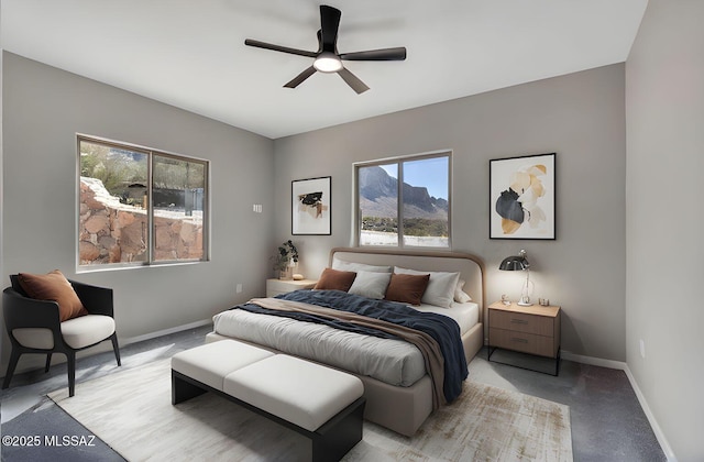 bedroom with baseboards, ceiling fan, and light colored carpet